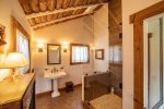 The bathroom features beautiful wood, tile and stonework